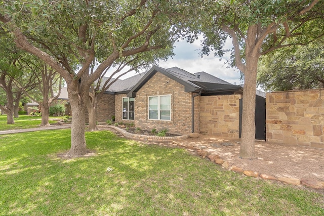 5807 Sterling Pl, Midland, TX 79707 - single story home with a front lawn, brick siding, and a shingled roof