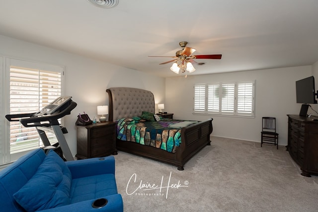 bedroom with visible vents, a ceiling fan, and carpet flooring