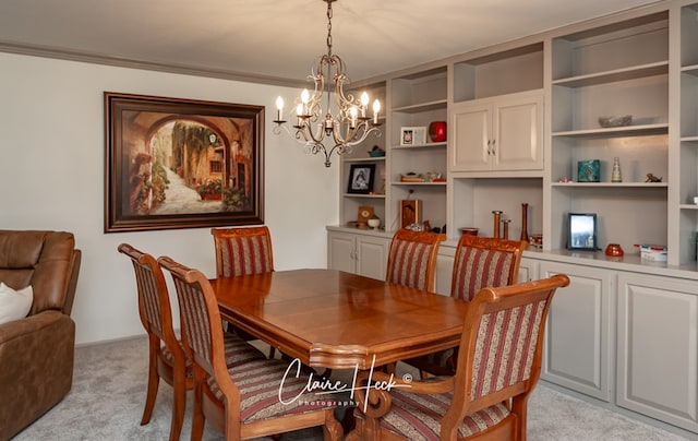 dining area with ornamental molding, light colored carpet, and an inviting chandelier