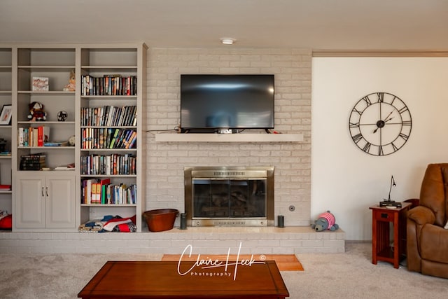 carpeted living room with a fireplace