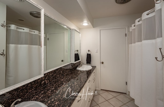 full bathroom featuring tile patterned flooring and vanity