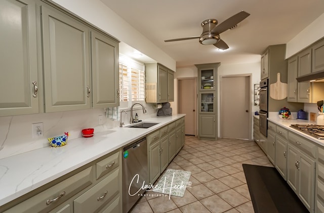 kitchen with ceiling fan, appliances with stainless steel finishes, gray cabinets, a sink, and light tile patterned flooring