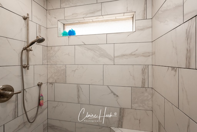 interior details featuring a tile shower