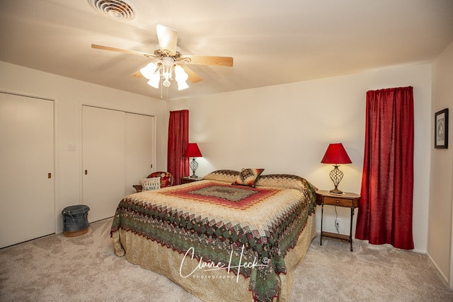 carpeted bedroom featuring visible vents and ceiling fan