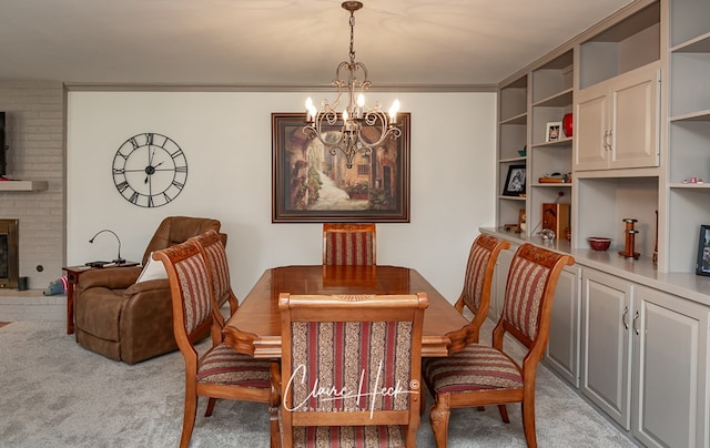 dining space with light carpet, a brick fireplace, and an inviting chandelier