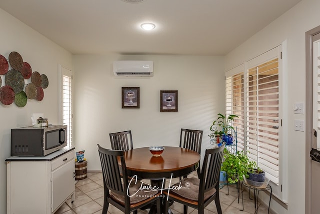 dining space featuring light tile patterned floors and a wall mounted AC