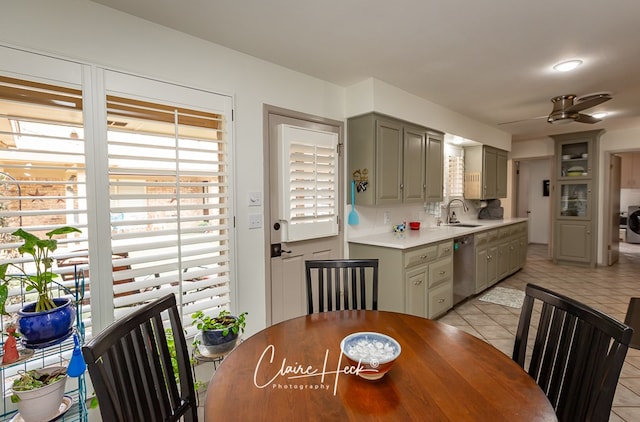 dining room with light tile patterned floors, washer / clothes dryer, and a ceiling fan