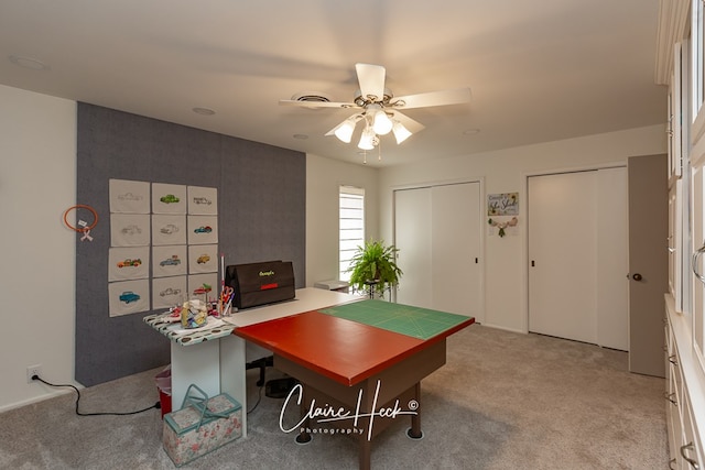 office with light carpet and a ceiling fan