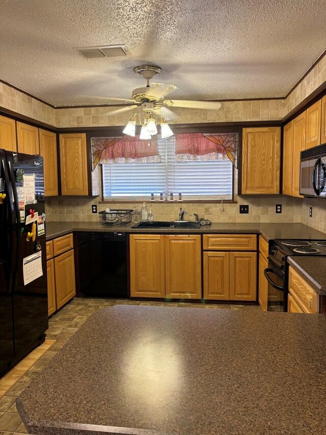 kitchen with black appliances, ceiling fan, sink, and a textured ceiling