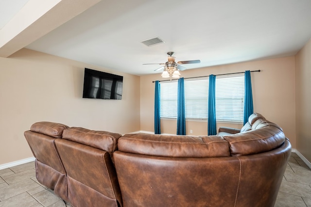 tiled living room featuring ceiling fan