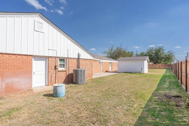 view of yard featuring an outdoor structure and central air condition unit