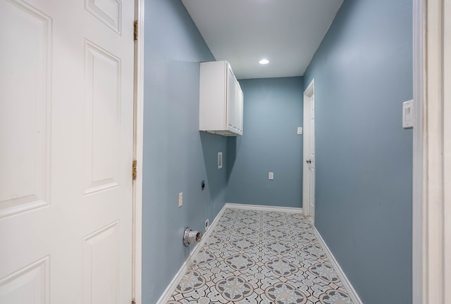 clothes washing area with light tile patterned flooring, cabinets, and hookup for an electric dryer