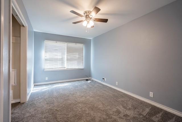 empty room featuring carpet flooring and ceiling fan