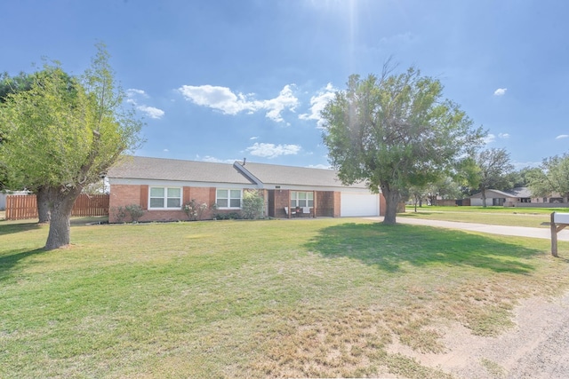 single story home featuring a garage and a front lawn