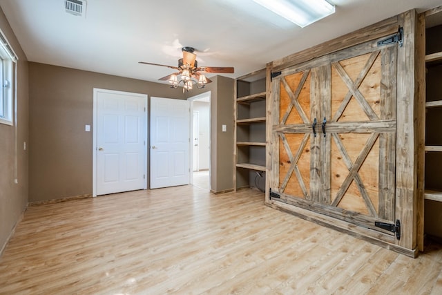 interior space featuring light wood-type flooring and ceiling fan