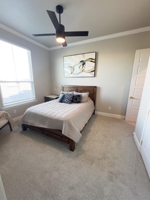 bedroom featuring light carpet, ceiling fan, and crown molding