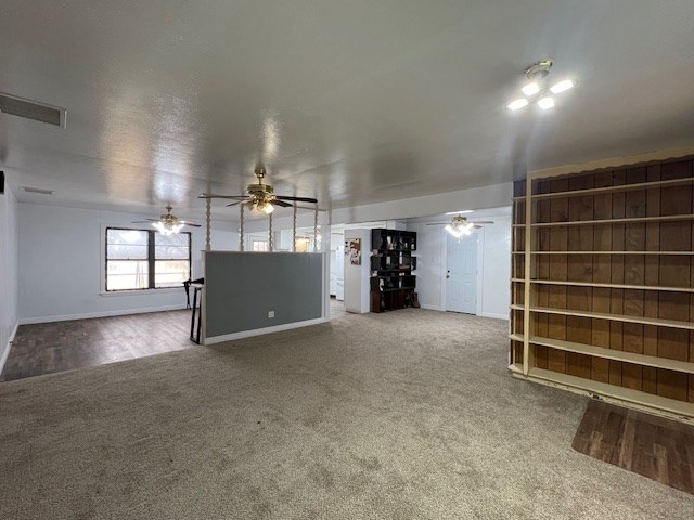 unfurnished living room with ceiling fan and carpet floors