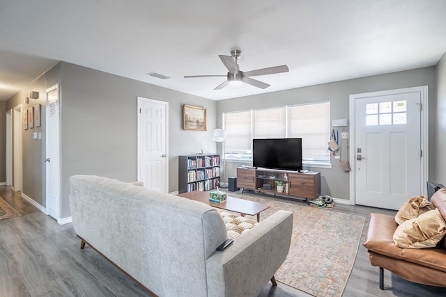 living room featuring ceiling fan and wood-type flooring