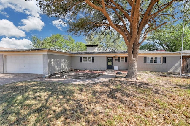 2010 Douglas Ave, Midland, TX 79701 - single story home featuring brick siding, an attached garage, and concrete driveway