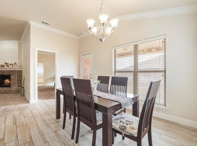 dining room featuring ornamental molding, lofted ceiling, a fireplace, and baseboards