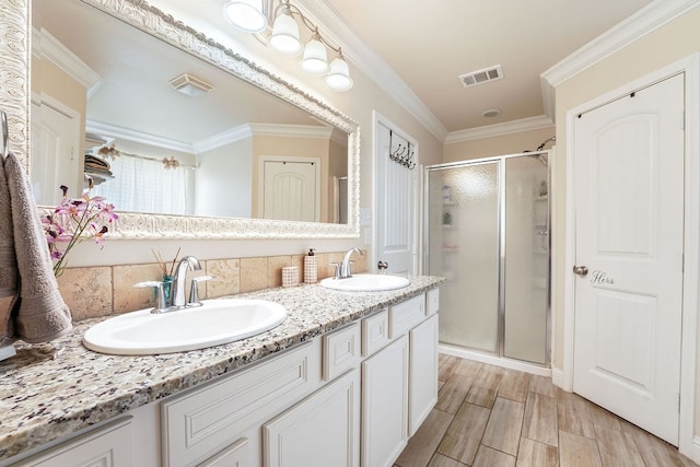 bathroom featuring visible vents, a sink, and a shower stall