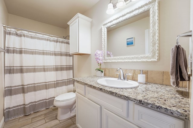 bathroom featuring vanity, wood finished floors, toilet, and a shower with curtain