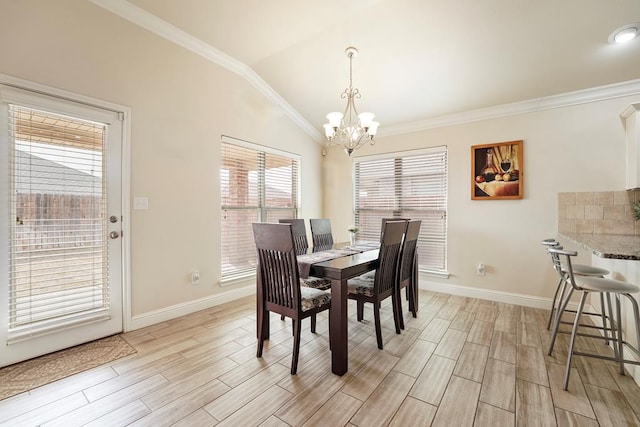 dining area featuring baseboards, ornamental molding, wood tiled floor, vaulted ceiling, and a notable chandelier