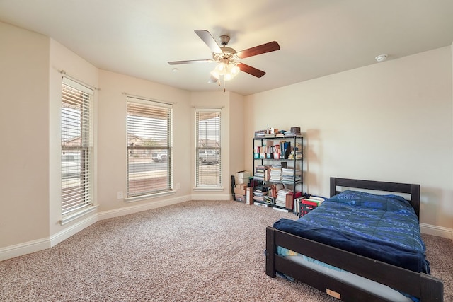 bedroom with ceiling fan, carpet floors, and baseboards