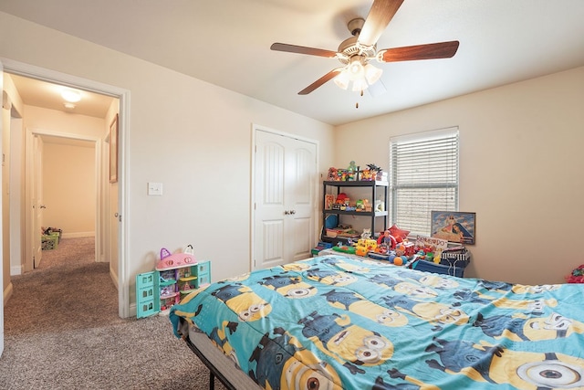 carpeted bedroom with a closet, ceiling fan, and baseboards