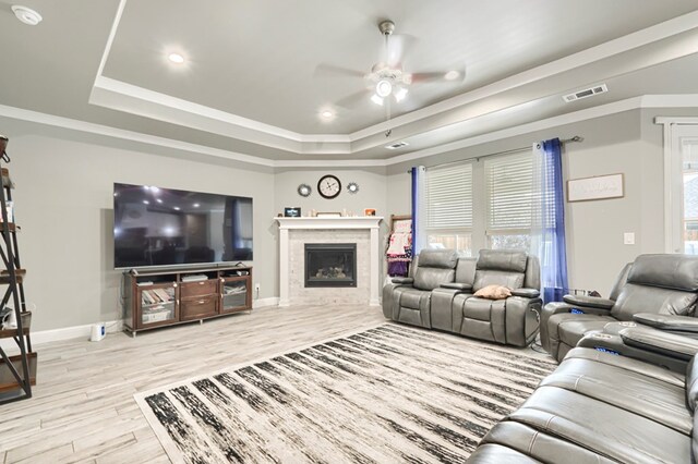 1706 Overshine Ln, Midland, TX 79705 - living room with a tray ceiling, ceiling fan, wood finished floors, baseboards, and a fireplace