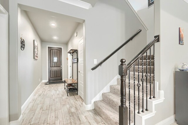 1706 Overshine Ln, Midland, TX 79705 - foyer entrance with light wood finished floors, stairway, baseboards, and recessed lighting