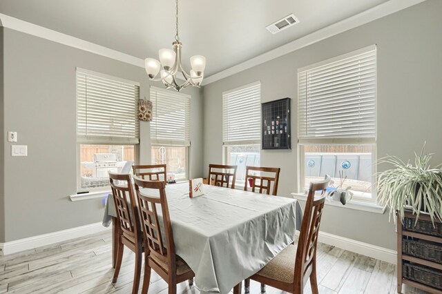 1706 Overshine Ln, Midland, TX 79705 - dining room with a chandelier, baseboards, and light wood-style floors