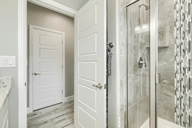 1706 Overshine Ln, Midland, TX 79705 - bathroom featuring a stall shower, vanity, and wood finished floors