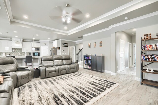 1706 Overshine Ln, Midland, TX 79705 - living room featuring a ceiling fan, light wood-style floors, a raised ceiling, recessed lighting, and baseboards