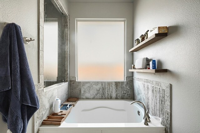 1706 Overshine Ln, Midland, TX 79705 - bathroom with a garden tub and a textured wall