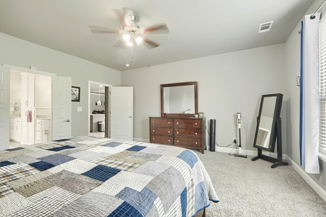 1706 Overshine Ln, Midland, TX 79705 - bedroom with light carpet, baseboards, ensuite bathroom, and ceiling fan