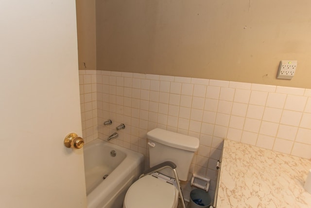 bathroom featuring toilet, tile walls, and a bathing tub