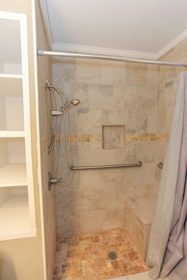 bathroom with a shower with curtain, ornamental molding, and a textured ceiling