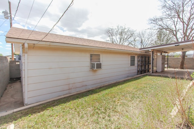 view of side of property featuring a lawn, cooling unit, and a patio area