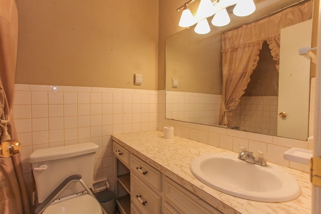 bathroom with vanity, toilet, and tile walls