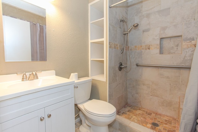 bathroom featuring vanity, toilet, and walk in shower