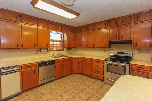 kitchen featuring a textured ceiling, sink, and stainless steel appliances