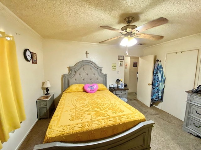 carpeted bedroom with ceiling fan, crown molding, and a textured ceiling