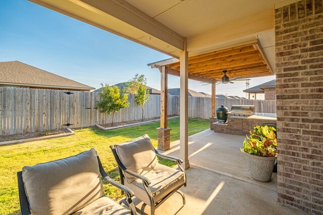 view of patio / terrace with area for grilling, a grill, and a fenced backyard