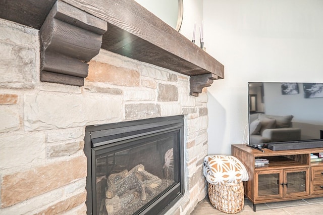 interior details with a stone fireplace