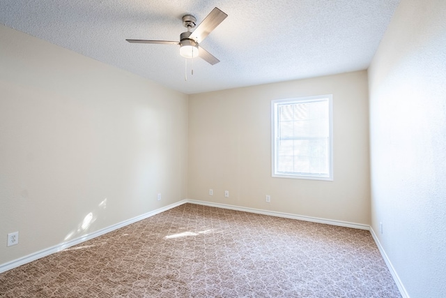 carpeted spare room featuring ceiling fan and a textured ceiling