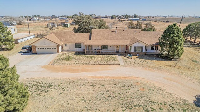 2701 S County Rd 1114, Midland, TX 79706 - view of front of home featuring a garage, covered porch, board and batten siding, and concrete driveway