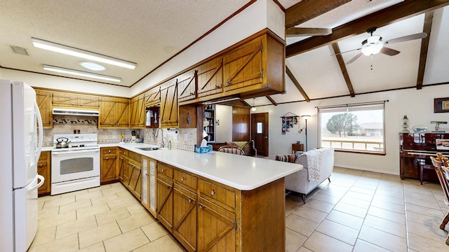 kitchen featuring white appliances, brown cabinetry, a peninsula, light countertops, and a sink