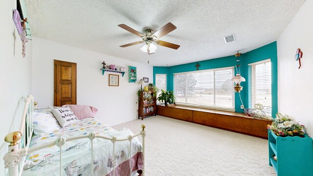 2701 S County Rd 1114, Midland, TX 79706 - bedroom with carpet floors, a ceiling fan, a textured ceiling, and visible vents