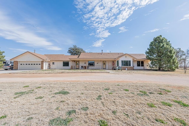 ranch-style home featuring an attached garage and board and batten siding